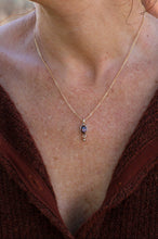 Load image into Gallery viewer, Necklace with a pendant worn by a person, close-up view.