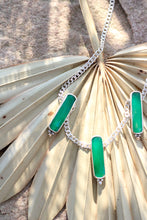 Load image into Gallery viewer, Necklace with green pendant on a palm leaf