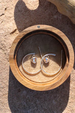 Load image into Gallery viewer, Silver hoop earrings with heart shaped opal charms in a wooden box on a stone surface