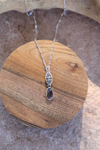 Load image into Gallery viewer, Silver necklace with a purple stone pendant on a wooden surface