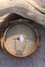Load image into Gallery viewer, Ring with a opal and rose zircon in a wooden box on a sandy surface