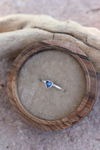 Load image into Gallery viewer, Heart-shaped blue opal gemstone ring on a wooden ring box with a natural background