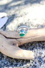 Load image into Gallery viewer, Ring with a collection of blue and green stones on a piece of driftwood against a rocky background