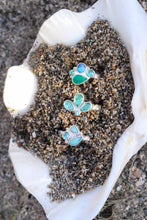 Load image into Gallery viewer, Three rings with blue and green stones on sand inside a shell