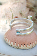 Load image into Gallery viewer, Silver bracelet with a turquoise stone on a pink woven surface
