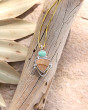 Load image into Gallery viewer, Necklace with a pendant featuring a turquoise and jasper stone on a wooden surface