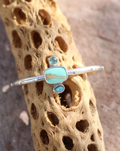 Load image into Gallery viewer, Turquoise colored stone bracelet on a textured brown surface