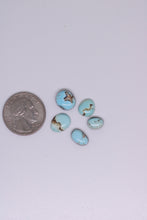 Load image into Gallery viewer, Turquoise stones with a quarter for scale on a white background
