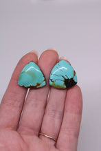 Load image into Gallery viewer, Turquoise stones on a hand against a white background
