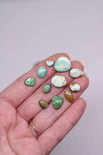 Load image into Gallery viewer, Hand holding various small, polished stones with a plain background
