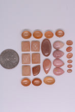 Load image into Gallery viewer, Collection of various shaped and colored stones on a white background with a coin for scale.
