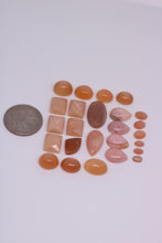 Load image into Gallery viewer, Collection of various shaped and sized stones on a white background with a coin for scale.
