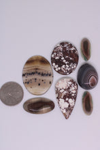 Load image into Gallery viewer, Collection of various agate stones on a white background
