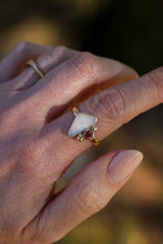Load image into Gallery viewer, Close-up of a hand wearing a ring with a triangular opal stone and a rose zircon  gemstone on a blurred natural background
