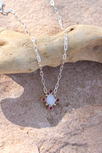 Load image into Gallery viewer, Necklace with a opal and garnet pendant on a wooden surface
