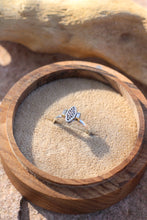 Load image into Gallery viewer, Silver ring with a vintage component  design next tow two baguette diamonds in a wooden box on a stone surface
