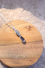 Load image into Gallery viewer, Silver necklace with a purple pendant on a wooden surface
