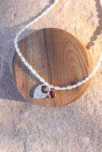 Load image into Gallery viewer, Necklace with a pearl chain, red gemstone pendant, and silver vintage heart lock charm on a wooden surface.
