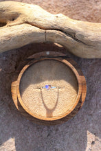 Load image into Gallery viewer, Wooden ring box with a heart shaped  opal ring inside, placed on sand with driftwood.
