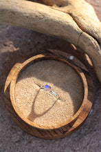 Load image into Gallery viewer, Wooden ring box with a heart shaped  opal ring inside, placed on sand with driftwood.
