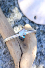 Load image into Gallery viewer, Silver cuff with opal and turquoise stones on a piece of driftwood with a sand dollar in the background
