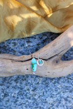 Load image into Gallery viewer, Necklace with turquoise colored stones on a piece of driftwood

